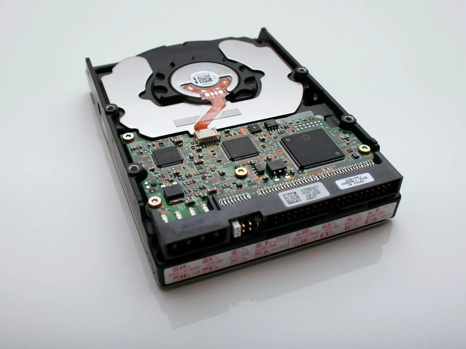 A computer hard drive with its green controller board visible