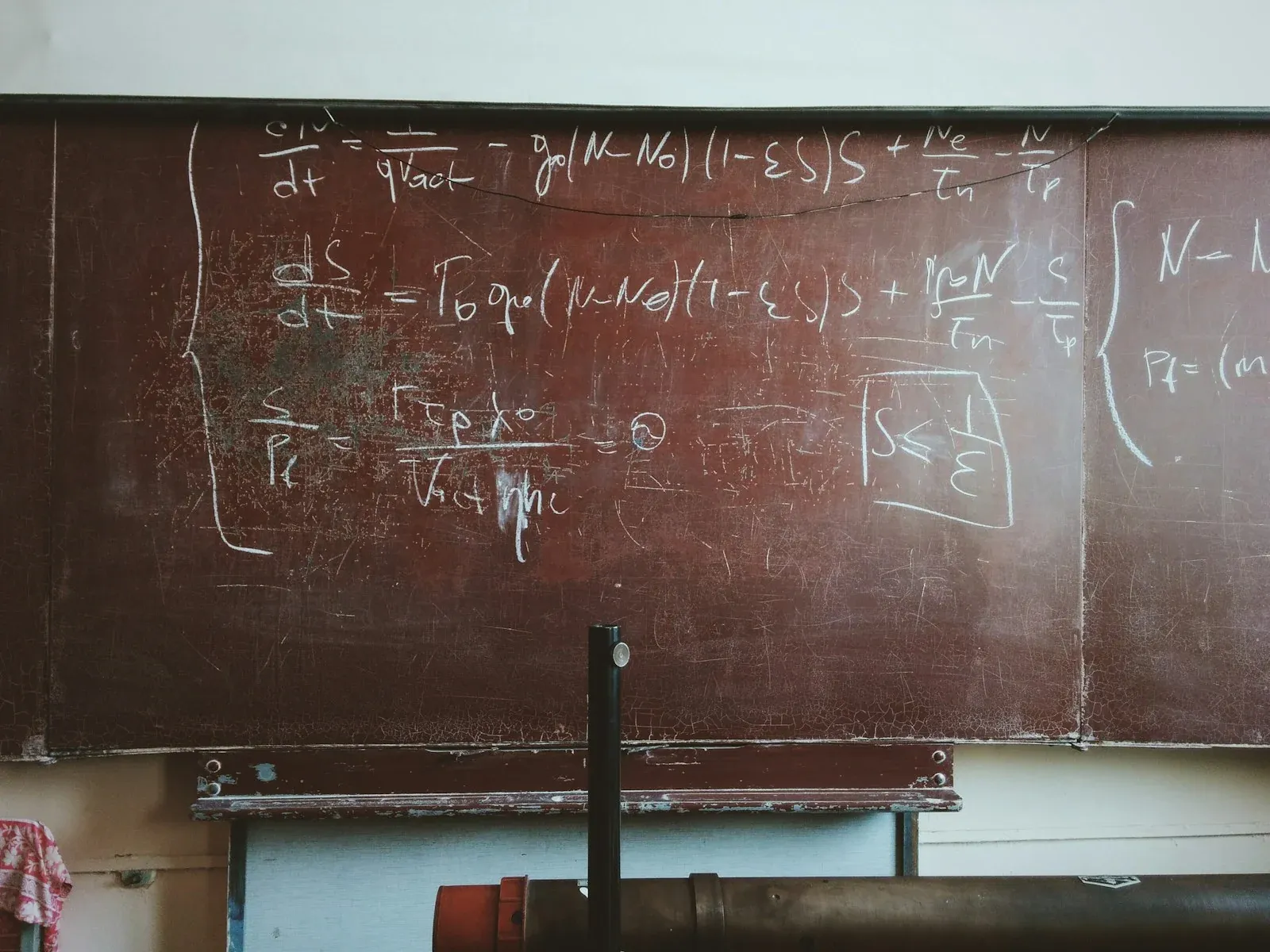 Mathematical equations written in chalk across a blackboard