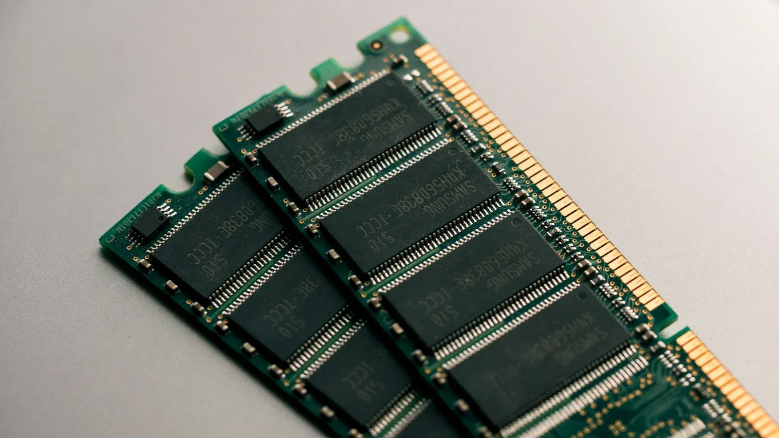 Computer memory modules with black chips on green circuit boards