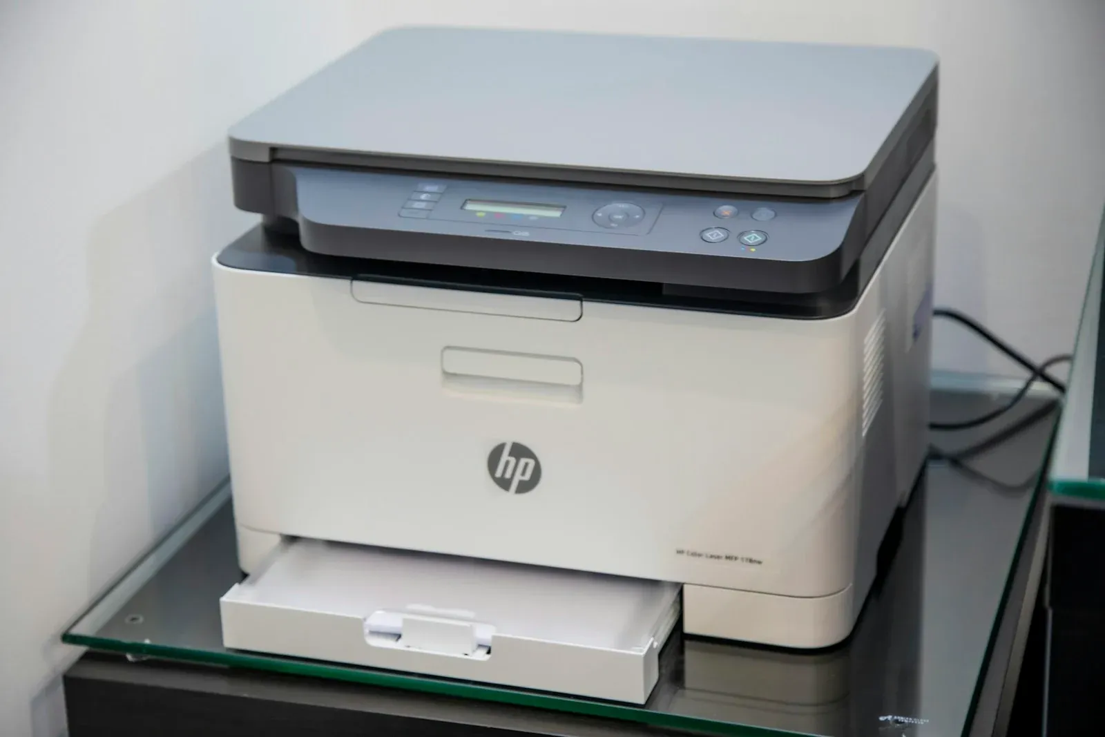 A desktop printer with a scanner and paper tray